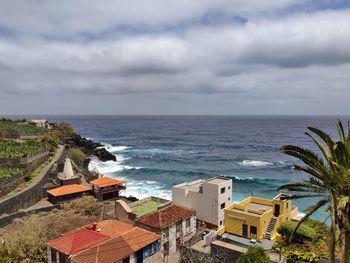 High angle view of swimming pool by sea against sky