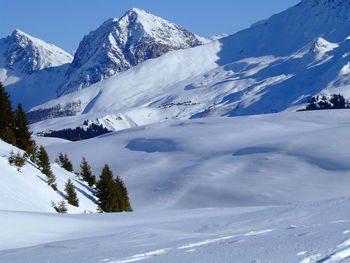 Scenic view of snow mountains against sky