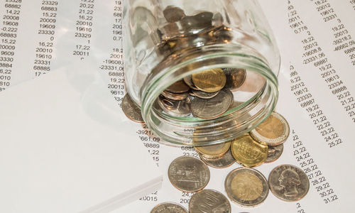 High angle view of coins in jar