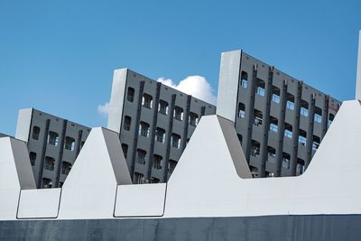Low angle view of buildings against clear blue sky