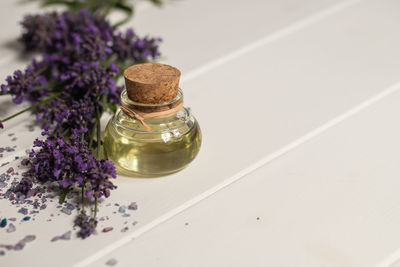 High angle view of purple flower in glass on table