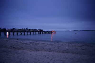 Pier over sea against sky at dusk