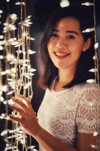 Close-up portrait of smiling young woman