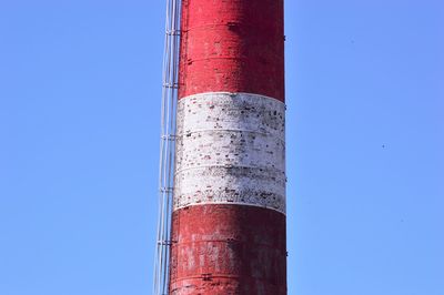 Low angle view of crane against clear blue sky