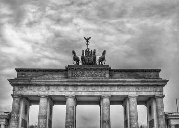 Low angle view of historical building against cloudy sky