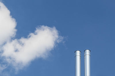 Low angle view of smoke stack against sky