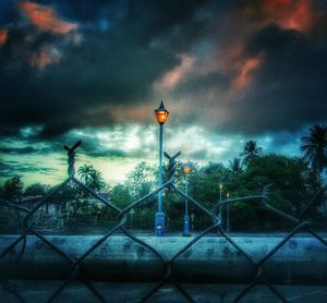 Street light against cloudy sky