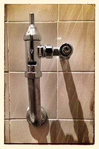 Close-up of faucet in bathroom