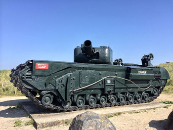 Train on field against clear sky