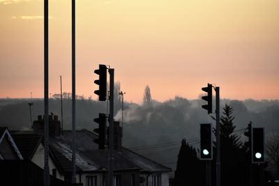 City street against sky during sunrise