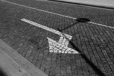 High angle view of arrow symbol on road