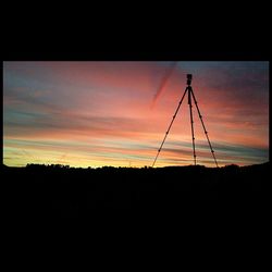 Silhouette of power lines against sky