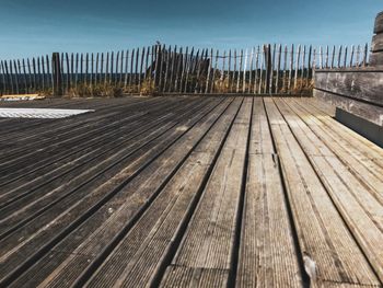 Wooden boardwalk against sky