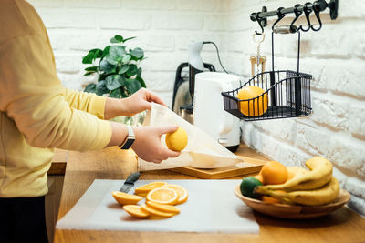 How to dry orange slices for holiday decor. process of drying orange slices in the oven. woman