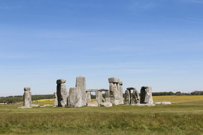 Old ruins on field against sky