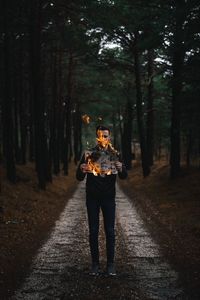 Full length of man standing on footpath amidst trees