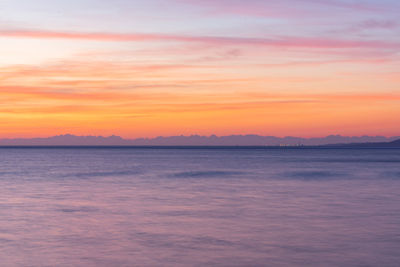 Scenic view of sea against romantic sky at sunset