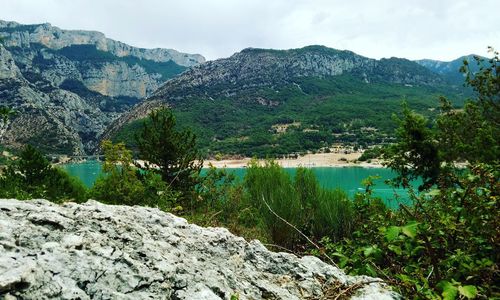 Scenic view of lake and mountains against sky