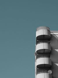 Low angle view of modern building against clear blue sky