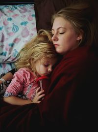 Low angle view of mother and girl on bed at home