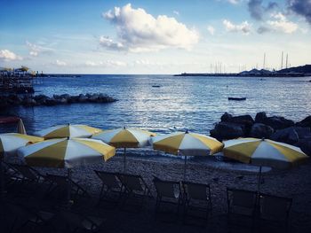 Sailboats in sea against sky