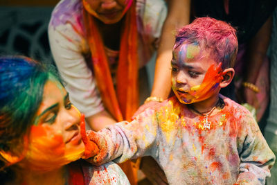 Portrait of smiling friends sitting at home