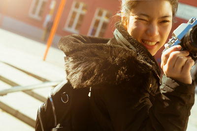 Portrait of smiling girl holding ice cream outdoors