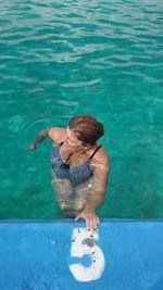 High angle view of woman swimming in pool