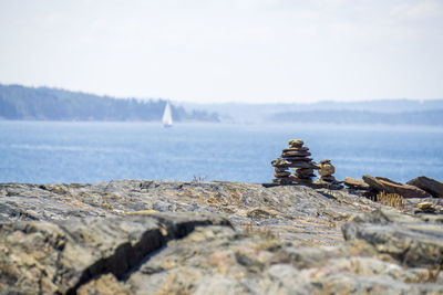 Stack of rocks on beach against sky