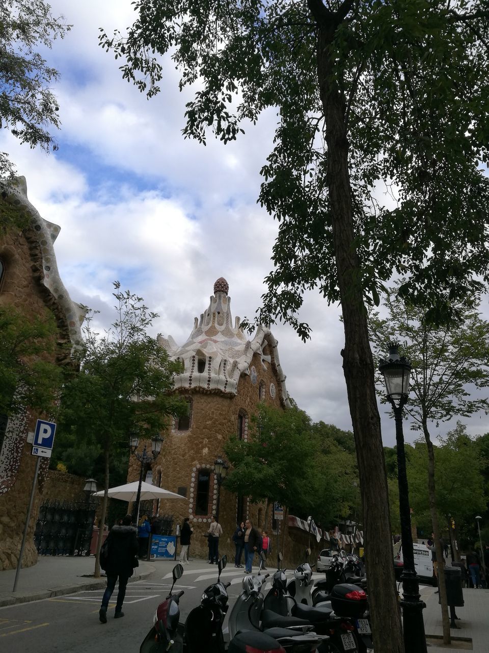 PEOPLE OUTSIDE TEMPLE AGAINST BUILDINGS