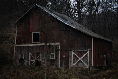 Old wooden house on field