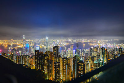 High angle view of city lit up at night