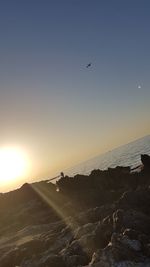 Scenic view of beach against sky during sunset