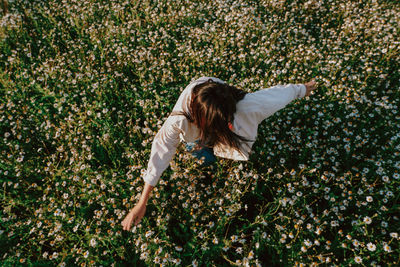 High angle view of woman with pink flowers