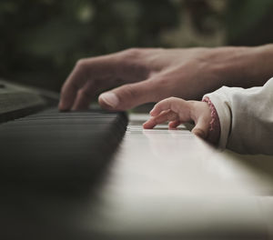Father and baby playing the piano