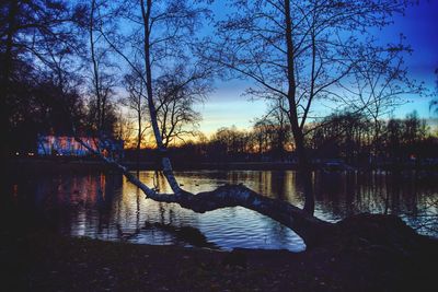 Scenic view of lake against sky at sunset