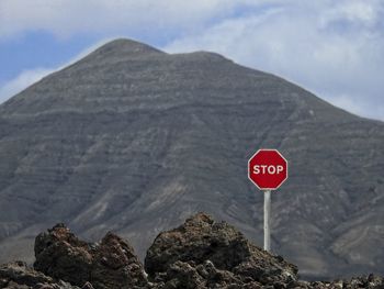 Information sign on rock against sky