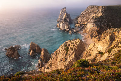 High angle view of rocks on sea shore