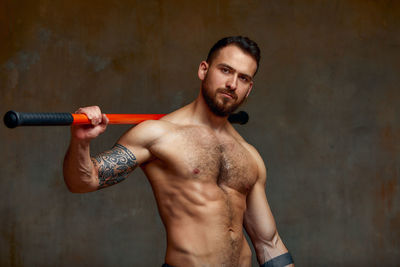 Portrait of young man exercising in gym