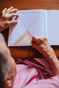 High angle view of man hand on table at home