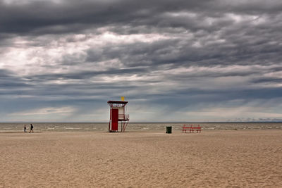 Lifeguard hut on beach against sky