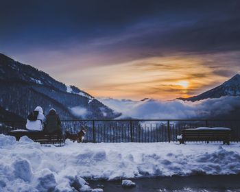 Scenic view of snowcapped mountains against sky during sunset