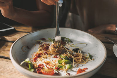 Cropped hand of person having food