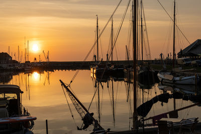 Sailboats in marina at sunset
