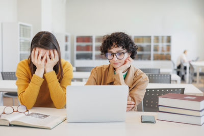 Young woman using laptop at office
