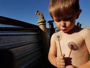 Boy standing against the sky