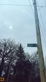 Low angle view of road sign against sky