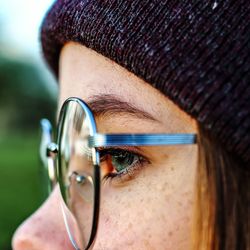 Close-up side view of woman wearing eyeglasses