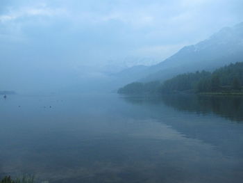 Scenic view of lake with mountains in background