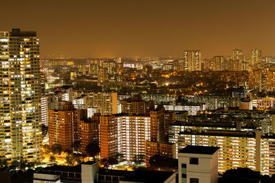 Aerial view of illuminated cityscape against sky at night